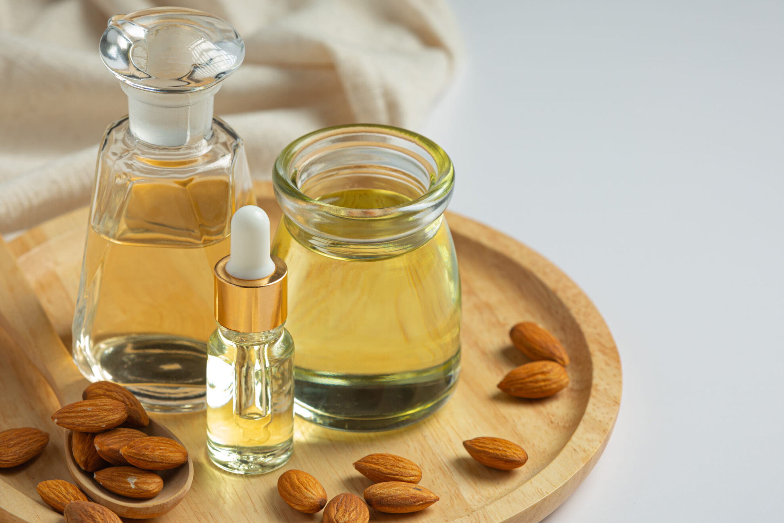 Almond oil in bottle on white background